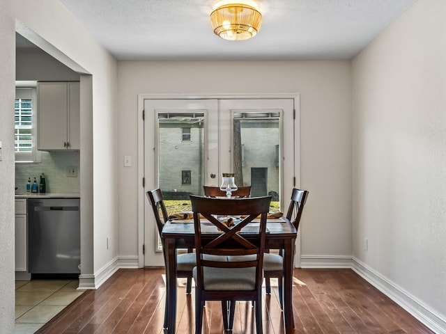 dining space featuring french doors and dark hardwood / wood-style flooring