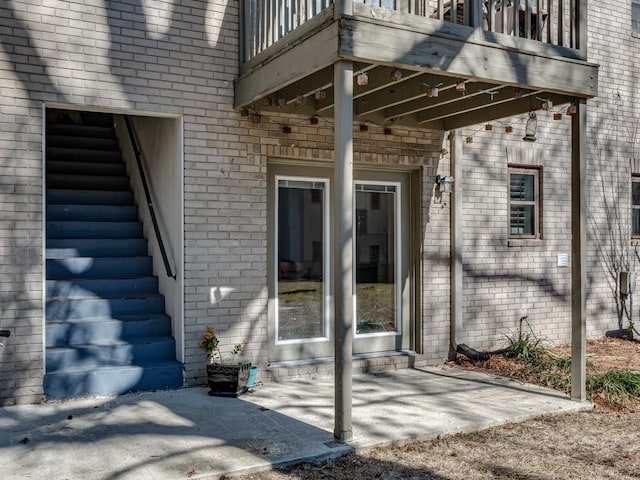 property entrance with a patio area and a balcony