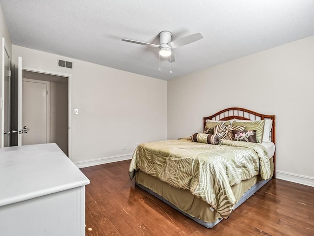 bedroom with ceiling fan and dark wood-type flooring