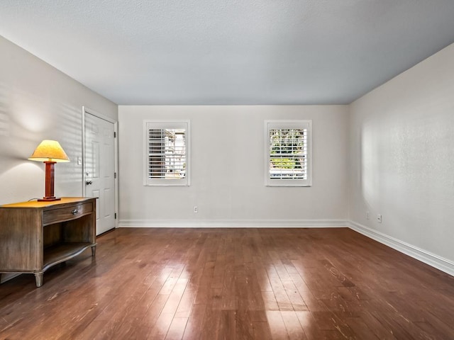 spare room with dark hardwood / wood-style flooring