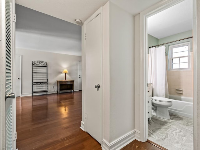 hallway with dark hardwood / wood-style flooring