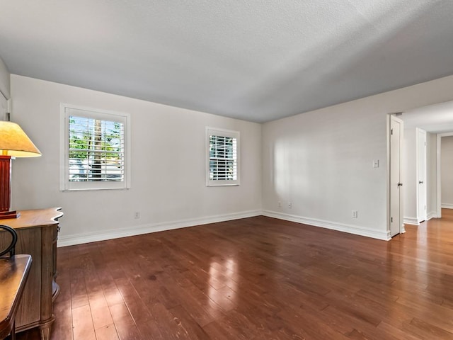 unfurnished living room featuring dark wood-type flooring