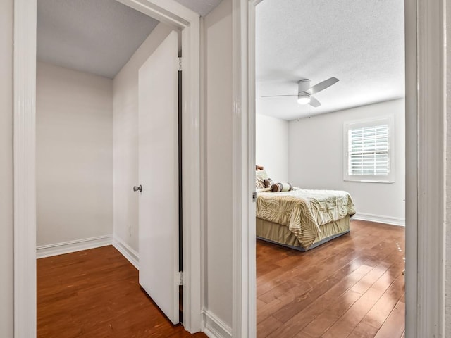 bedroom with ceiling fan and wood-type flooring