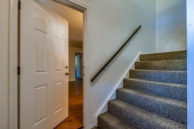 staircase with wood-type flooring