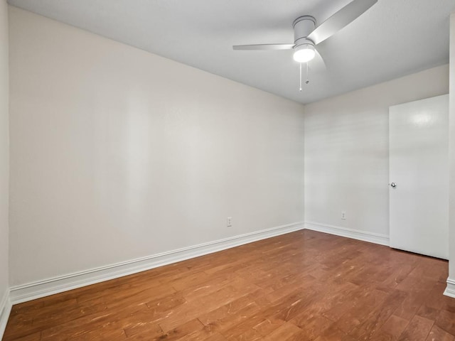 spare room with ceiling fan and wood-type flooring