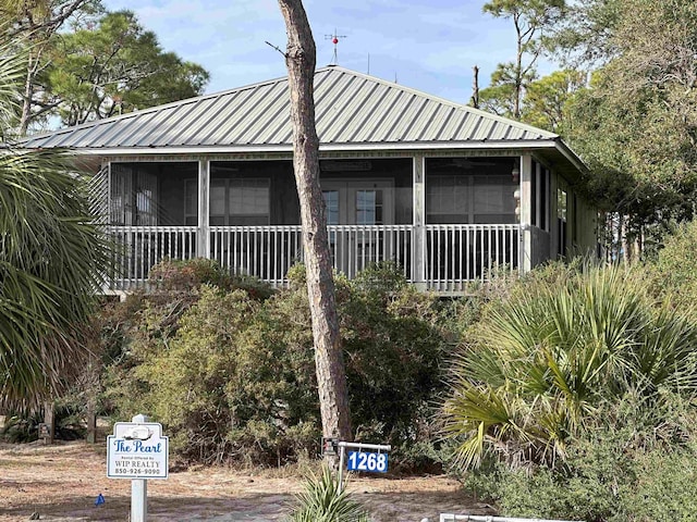 view of side of property with a sunroom