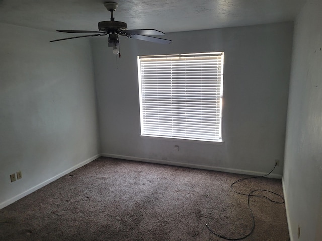 spare room with carpet and ceiling fan