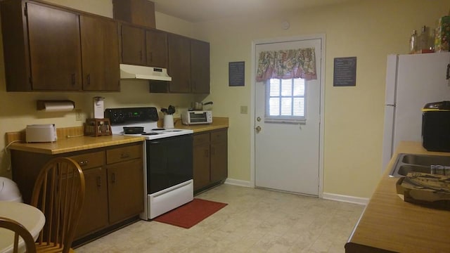 kitchen featuring dark brown cabinetry and white appliances