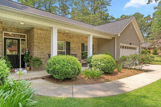 3524 Rosemont Ridge Rd, Tallahassee, FL 32312 - view of front facade with brick siding, a shingled roof, an attached garage, and covered porch