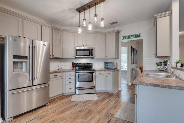 3524 Rosemont Ridge Rd, Tallahassee, FL 32312 - kitchen featuring stainless steel appliances, tasteful backsplash, light wood-style floors, pendant lighting, and light countertops