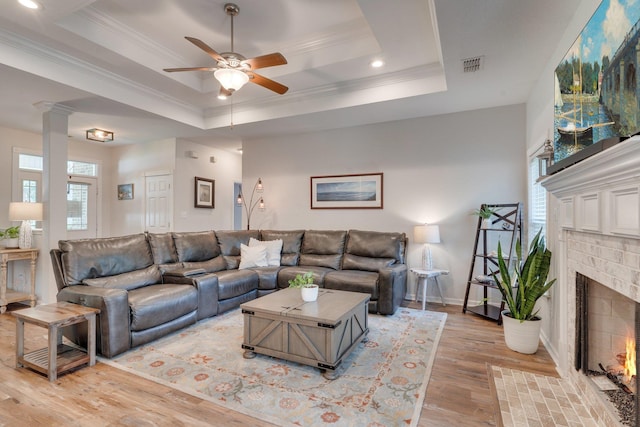 3524 Rosemont Ridge Rd, Tallahassee, FL 32312 - living room with a raised ceiling, ceiling fan, ornamental molding, a fireplace, and light wood-type flooring