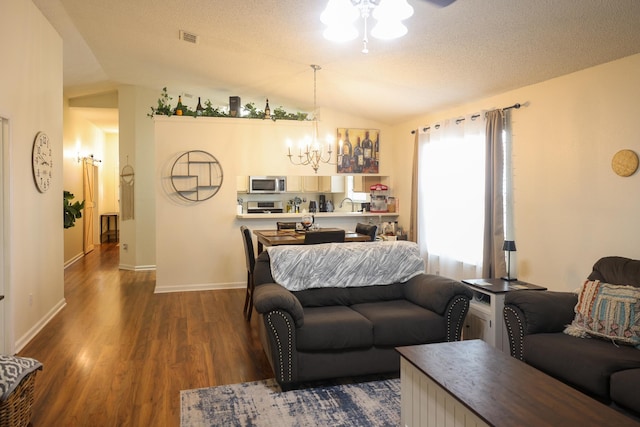 330 Dreadnaught Ct, Tallahassee, FL 32312 - living room with a chandelier, dark wood-style flooring, lofted ceiling, ceiling fan, and baseboards