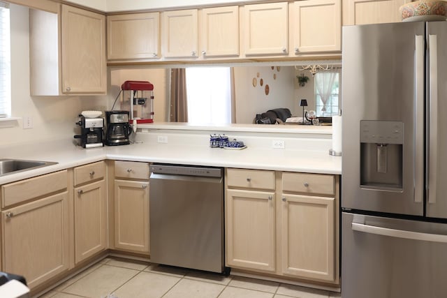 330 Dreadnaught Ct, Tallahassee, FL 32312 - kitchen with stainless steel appliances, light countertops, light tile patterned floors, light brown cabinetry, and a peninsula