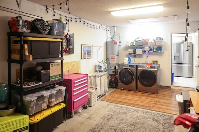 330 Dreadnaught Ct, Tallahassee, FL 32312 - laundry room featuring washer and clothes dryer, water heater, and a textured ceiling