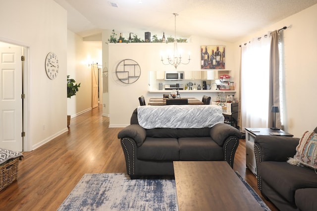 330 Dreadnaught Ct, Tallahassee, FL 32312 - living room featuring a chandelier, lofted ceiling, wood finished floors, and baseboards