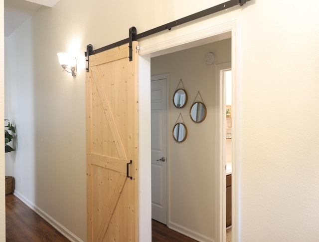 330 Dreadnaught Ct, Tallahassee, FL 32312 - corridor featuring a barn door, dark wood-type flooring, and baseboards
