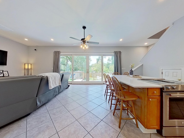 1324 Branch St, Tallahassee, FL 32303 - kitchen featuring stainless steel electric stove, a ceiling fan, open floor plan, a kitchen breakfast bar, and light countertops