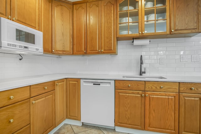 1324 Branch St, Tallahassee, FL 32303 - kitchen featuring white appliances, backsplash, and brown cabinets