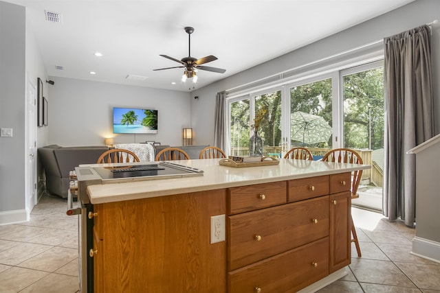 1324 Branch St, Tallahassee, FL 32303 - kitchen with light tile patterned flooring, a ceiling fan, light countertops, brown cabinets, and recessed lighting