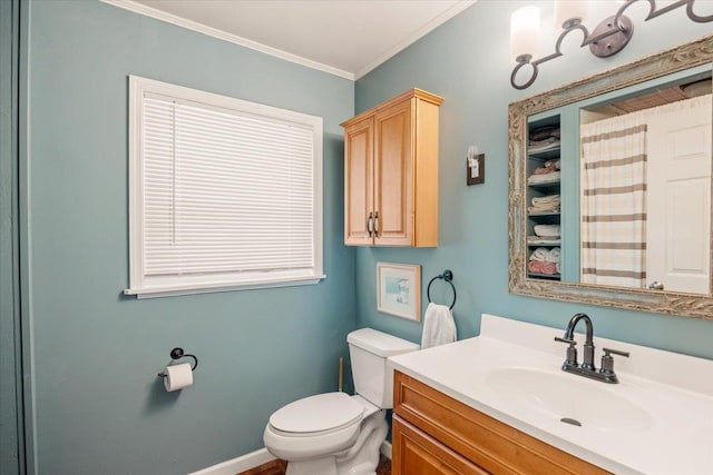 bathroom featuring vanity, toilet, and ornamental molding