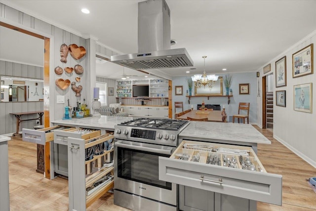 kitchen featuring hanging light fixtures, crown molding, a chandelier, island range hood, and high end range