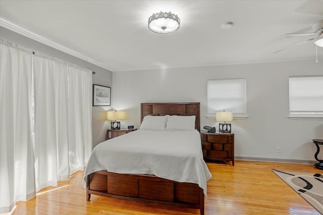 bedroom with light wood-type flooring, ceiling fan, and ornamental molding