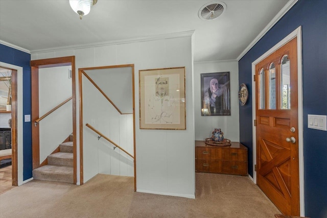 entryway featuring light colored carpet and ornamental molding