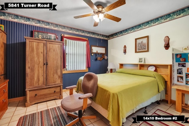5481 Turner Rd, Perry, FL 32348 - bedroom with wallpapered walls, light tile patterned floors, baseboards, and a ceiling fan
