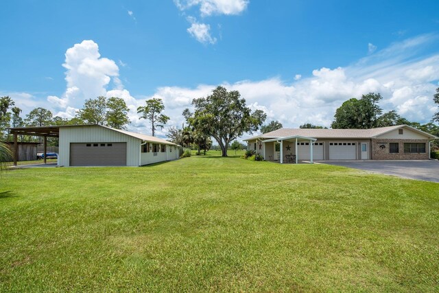 5481 Turner Rd, Perry, FL 32348 - view of grassy yard with driveway and a garage