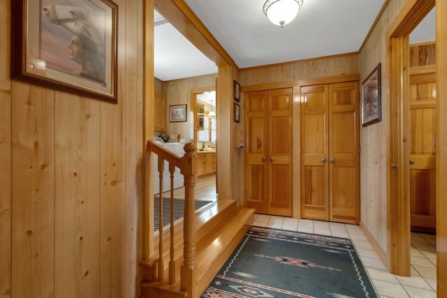 5481 Turner Rd, Perry, FL 32348 - doorway to outside featuring light tile patterned flooring, wood walls, and crown molding