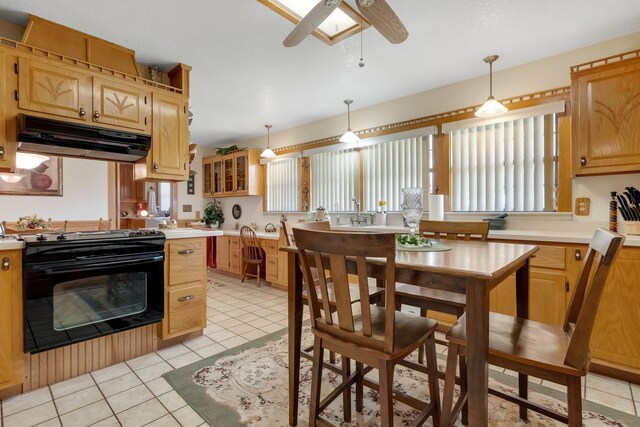 5481 Turner Rd, Perry, FL 32348 - kitchen featuring black range with gas stovetop, under cabinet range hood, ceiling fan, and light countertops
