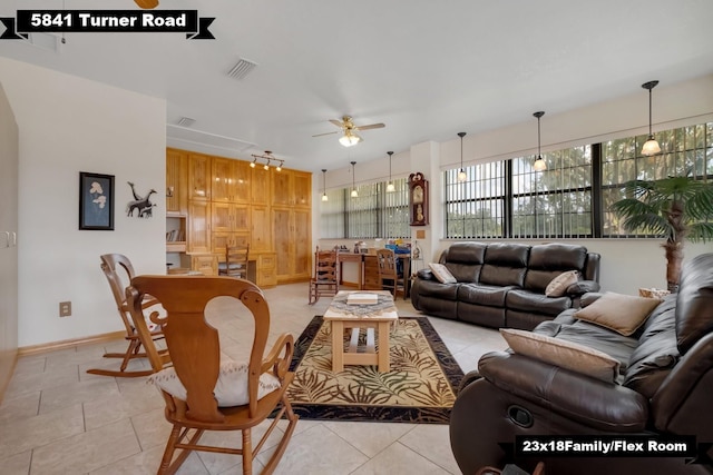 5481 Turner Rd, Perry, FL 32348 - living area with ceiling fan, light tile patterned floors, and baseboards