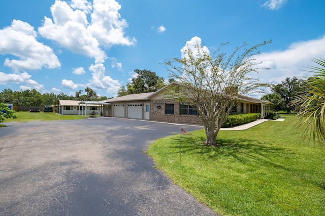 5481 Turner Rd, Perry, FL 32348 - single story home with an attached garage, driveway, a front lawn, and brick siding