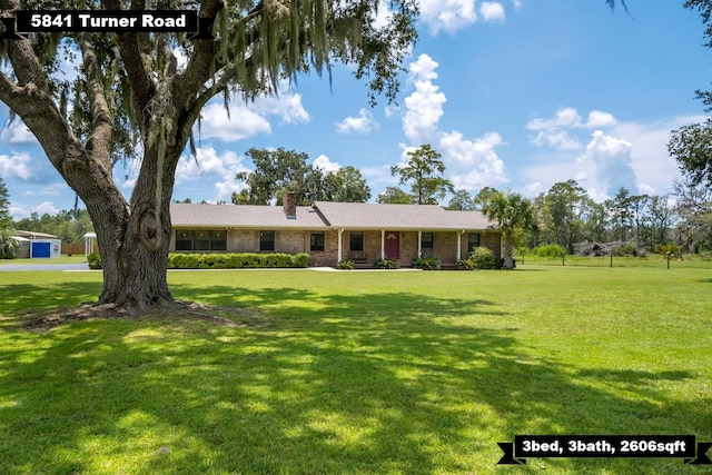 5481 Turner Rd, Perry, FL 32348 - ranch-style house with a chimney, a front lawn, and brick siding