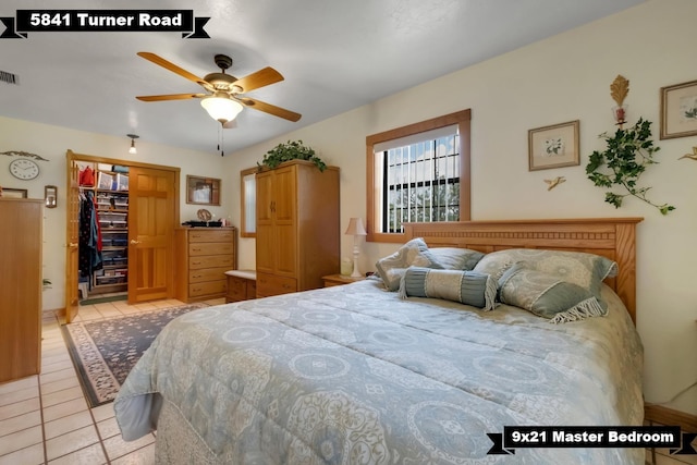 5481 Turner Rd, Perry, FL 32348 - bedroom featuring light tile patterned floors, a spacious closet, a closet, and a ceiling fan