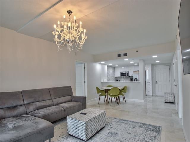 300 S Duval St Unit 2006, Tallahassee, FL 32301 - living area featuring baseboards and a chandelier