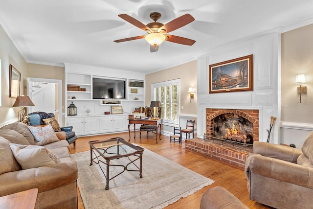 1244 Salem Rd, Havana, FL 32333 - living room with a brick fireplace, a ceiling fan, ornamental molding, and light wood-style flooring