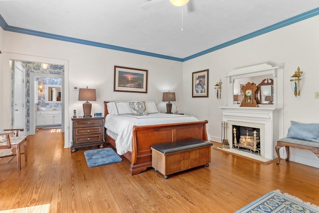 1244 Salem Rd, Havana, FL 32333 - bedroom featuring light wood-style flooring, crown molding, a warm lit fireplace, and a ceiling fan