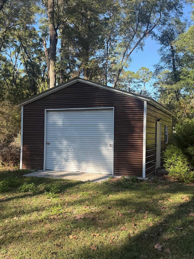 garage featuring a lawn