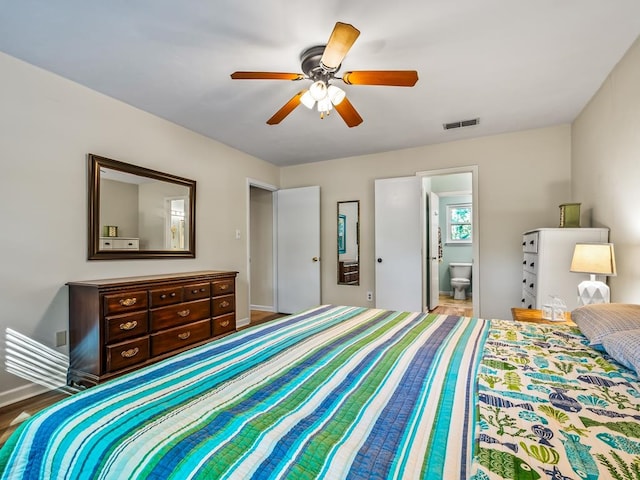 bedroom featuring ensuite bath, ceiling fan, and hardwood / wood-style flooring