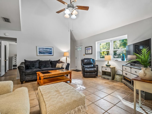 tiled living room with high vaulted ceiling and ceiling fan