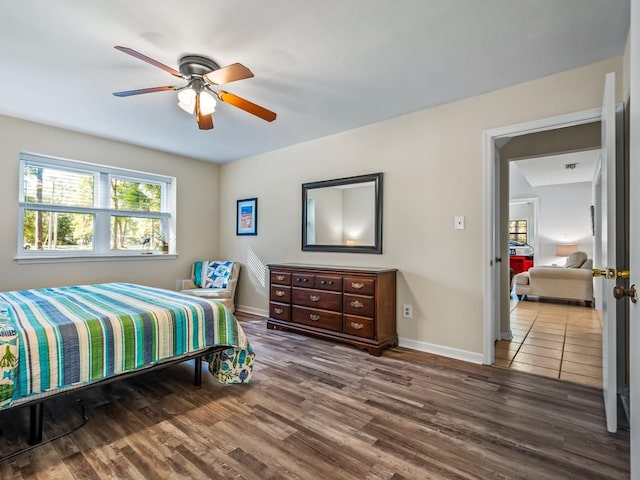 bedroom with ceiling fan and hardwood / wood-style flooring