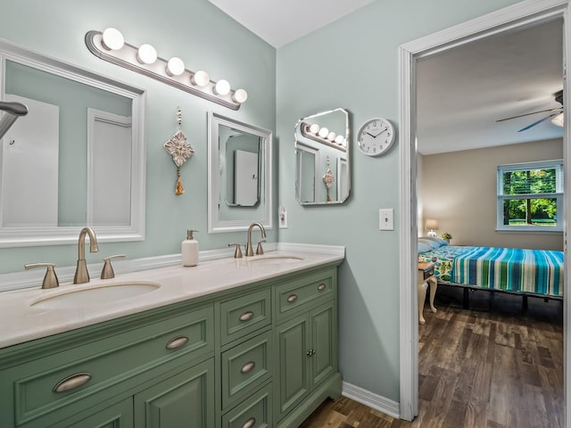 bathroom featuring wood-type flooring, vanity, and ceiling fan