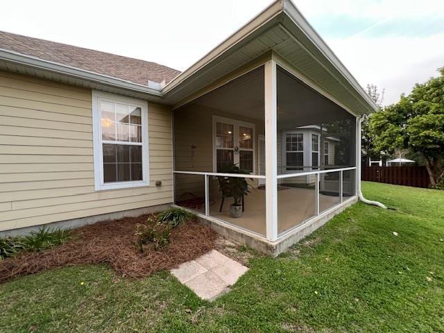 2541 Lagrange Trl, Tallahassee, FL 32312 - back of house with a sunroom, a yard, and a shingled roof