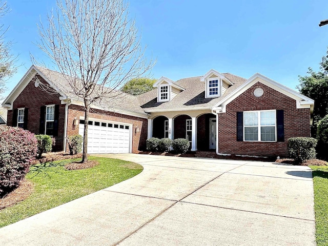 2541 Lagrange Trl, Tallahassee, FL 32312 - view of front of property with brick siding, concrete driveway, a garage, and a front lawn