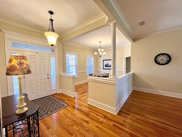 2541 Lagrange Trl, Tallahassee, FL 32312 - entrance foyer with a chandelier, wood finished floors, ornate columns, and crown molding
