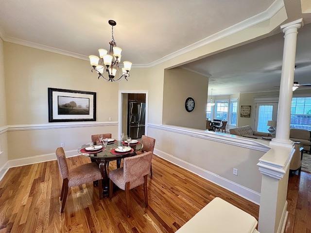 2541 Lagrange Trl, Tallahassee, FL 32312 - dining space with ornate columns, crown molding, wood finished floors, and a chandelier