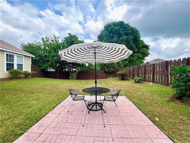 2541 Lagrange Trl, Tallahassee, FL 32312 - fenced backyard with a patio area and outdoor dining area