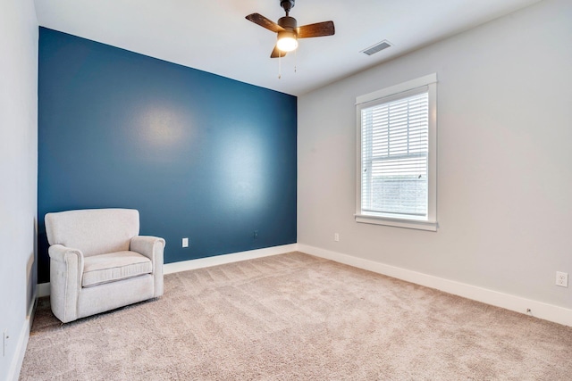 unfurnished room featuring light colored carpet and ceiling fan