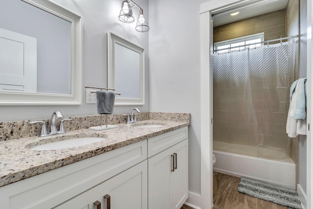 full bathroom featuring toilet, wood-type flooring, shower / washtub combination, and vanity